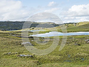 Beatiful northern artic landscape, tundra in Swedish Lapland with blue Duottar lake, green hills and mountains at