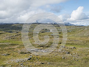 Beatiful northern artic landscape, tundra in Swedish Lapland with blue Duottar lake, green hills and mountains at