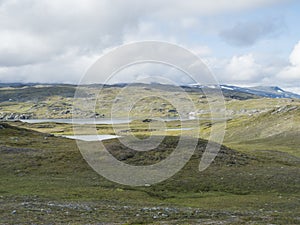 Beatiful northern artic landscape, tundra in Swedish Lapland with blue Duottar lake, green hills and mountains at