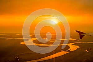 Beatiful orange sunset over the river,captured from aircraft