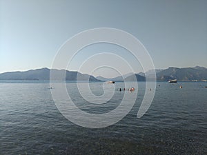 Beatiful sea panorama. Beach scene at Pukka region, boats, sea, tourists