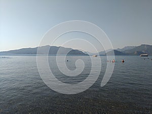 Beatiful sea panorama. Beach scene at Pukka region, boats, sea, tourists