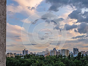 Beatiful urban cityscape with colorful dusk sky over park and high rises in Kyiv city