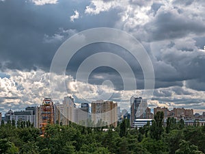 Beatiful urban cityscape with stormy sky over park and high rises in Kyiv city