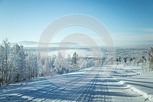 A beatiful winter scenery with a road. Woods in Norway.