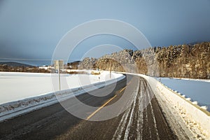 A beatiful winter scenery with a road. Woods in Norway.