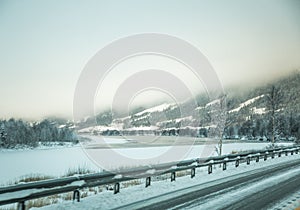 A beatiful winter scenery with a road. Woods in Norway.