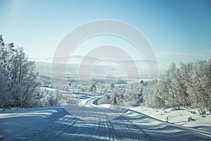 A beatiful winter scenery with a road. Woods in Norway.