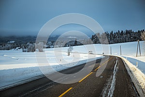 A beatiful winter scenery with a road. Woods in Norway.