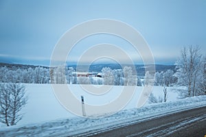 A beatiful winter scenery with a road. Woods in Norway.