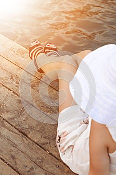 Beatiful woman legs on a natural wooden background with high heeles shoes. Fashion background. Cropped image of pretty young woman