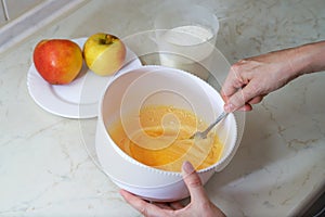 Beating eggs and sugar making dough