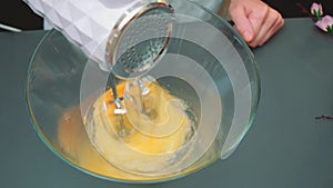 Beating a mixer raw eggs and sugar with a mixer