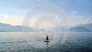 Beautfiful view of a boat sailing on the lake Maggiore, Italy