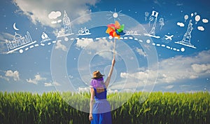 Purple hair girl with pinwheel at wheat field