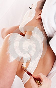 Beautician apply mask to girl. Massage. photo