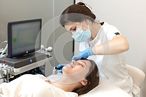 Beautician Applying Alginate Mask On Female Face