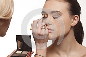 Beautician applying eye makeup