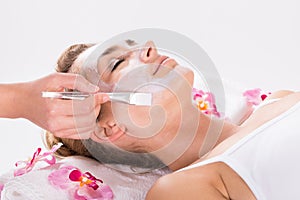Beautician Applying Mask On Customer`s Face At Salon