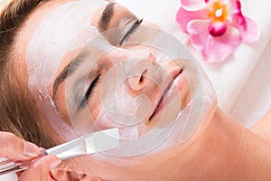 Beautician Applying Mask On Customer\'s Face At Salon