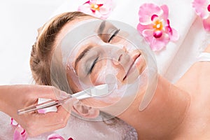 Beautician Applying Mask On Customer's Face At Salon