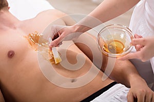 Beautician Applying Wax On Man`s Chest