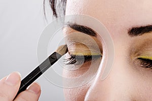 Beautician artist applying makeup