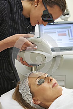 Beautician Carrying Out Fractional Laser Treatment photo