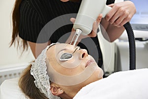 Beautician Carrying Out Fractional Laser Treatment photo