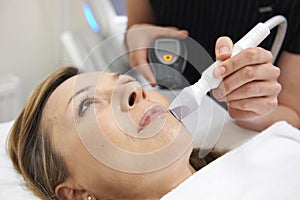 Beautician Carrying Out Ultrasound Skin Rejuvenation Treatment photo
