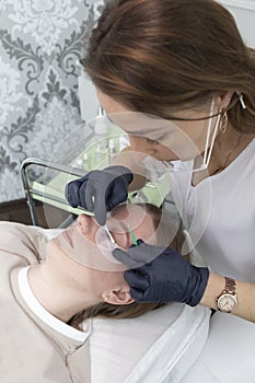 Beautician Cleans Lashes Of Young Woman With Eye Patches Before Laminating Eyelash Beauty