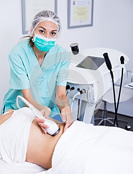 Beautician doing cryoliposuction