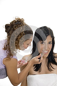 Beautician doing makeup on female face