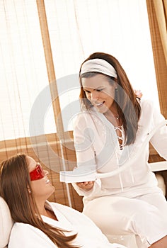 Beautician doing tooth whitening photo