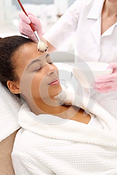 Beautician .Face mask applied cosmetic brush photo