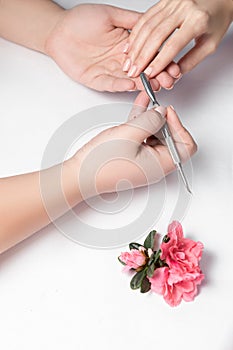 Beautician file nails to a customer.