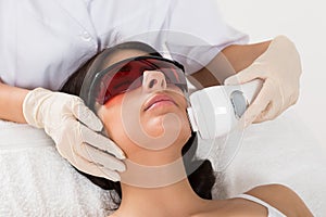 Beautician giving epilation laser treatment