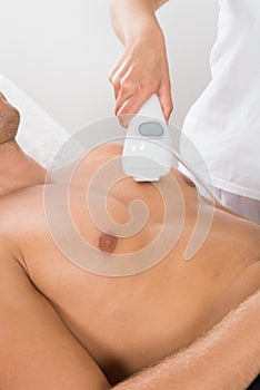 Beautician Giving Laser Epilation On Man`s Chest