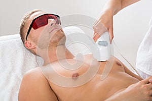 Beautician Giving Laser Epilation On Man`s Chest