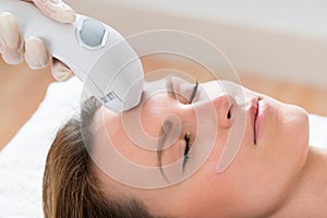 Beautician Giving Laser Epilation Treatment To Woman Face