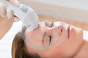 Beautician Giving Laser Epilation Treatment To Woman Face photo