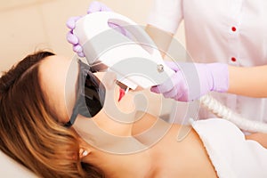 Beautician Giving Laser Epilation Treatment To Young Woman`s Face At Beauty Clinic.