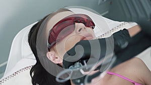 Beautician in gloves conducts the procedure of ultrasound skin restoration