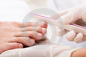 Beautician Hand Filling Person`s Nail