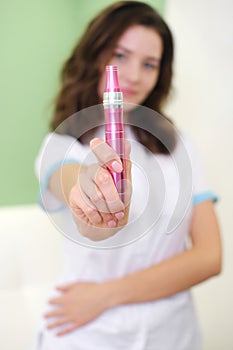 The Beautician Holds In His Hands A Dermapen, A Tool For Mesotherapy And Cell Regeneration. photo