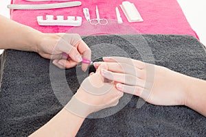 Nail polishes in nailcare salon woman doing nail manicure photo