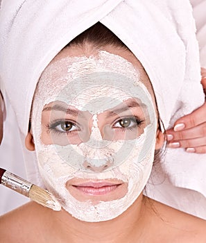 Beautician make mask to girl. Massage. photo