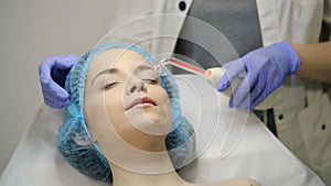 Beautician makes Facial Darsonval Therapy