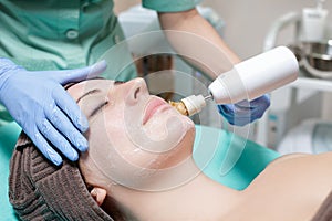 Beautician makes mechanical cleaning of the face.