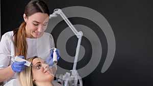 A beautician makes smoothing of deep wrinkles on a woman's forehead. Cosmetic procedure in a beauty salon.